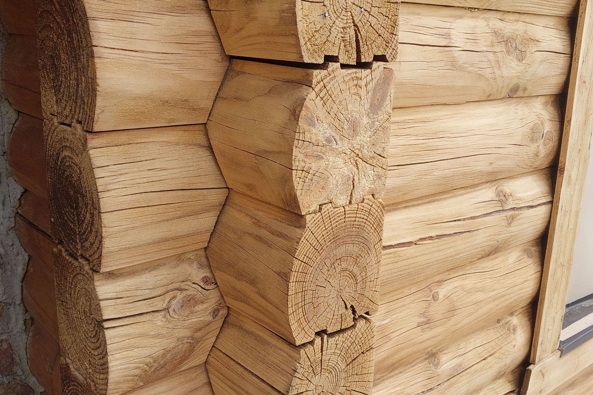 Close-up of log home corner joinery and chinking between stacked logs