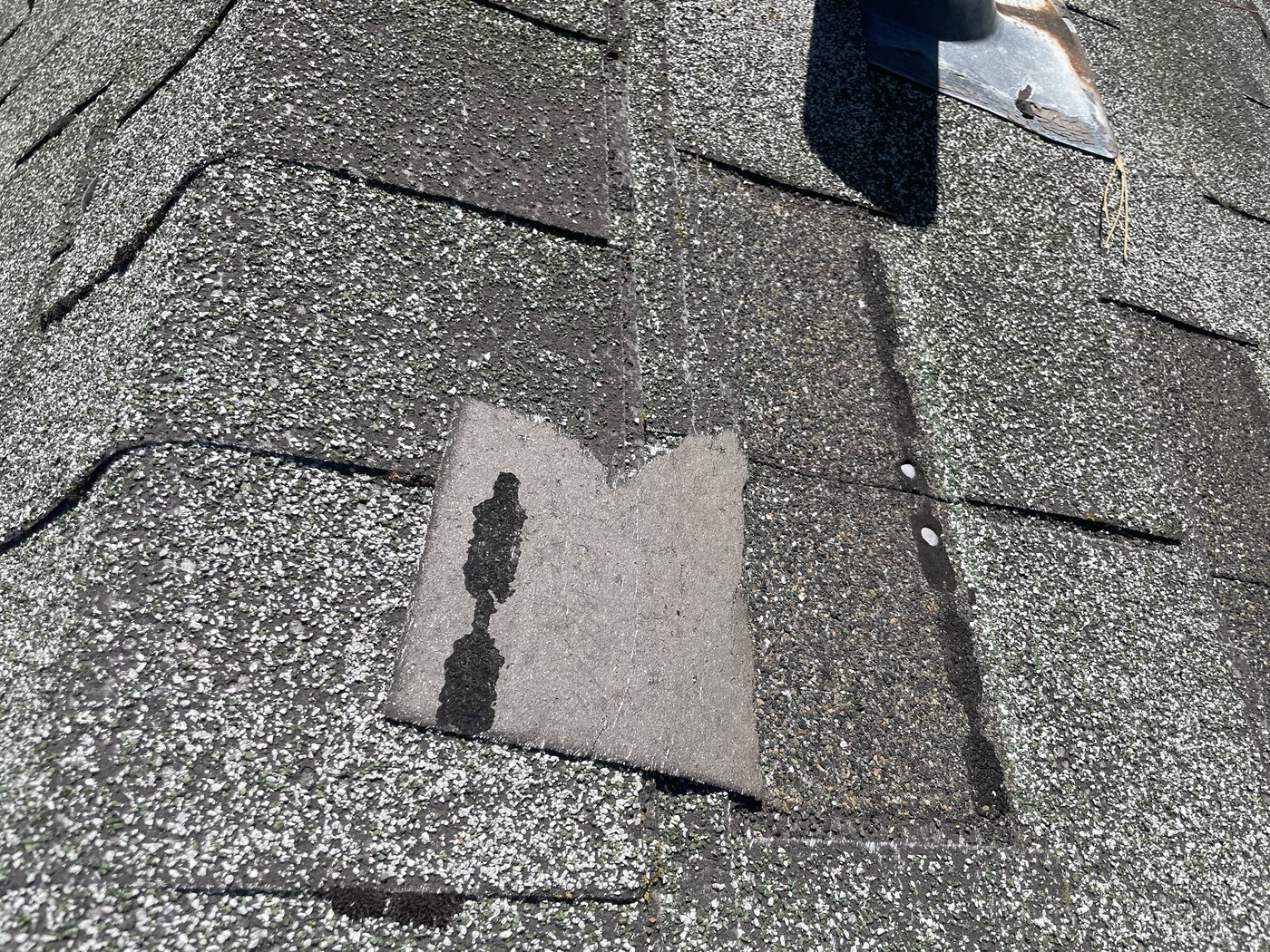 Damaged roof shingle documented during a home inspection